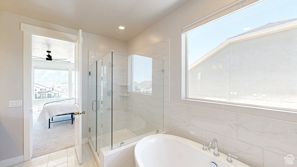 Ensuite bathroom featuring a freestanding tub, a marble finish shower, ceiling fan, and recessed lighting