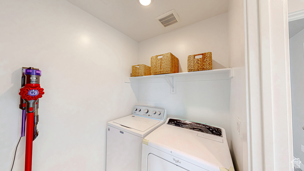 Laundry room with washer and clothes dryer