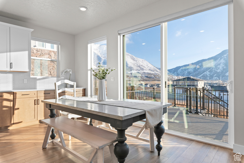 Dining space with a mountain view and light wood-type flooring