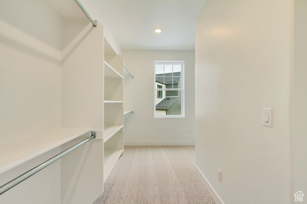 Walk in closet featuring light carpet