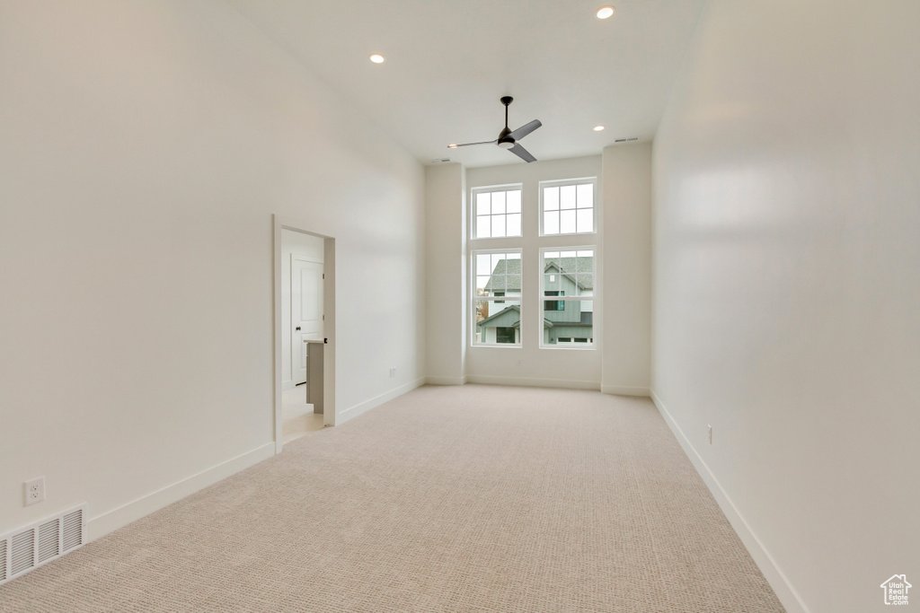 Spare room with light colored carpet, ceiling fan, recessed lighting, and baseboards