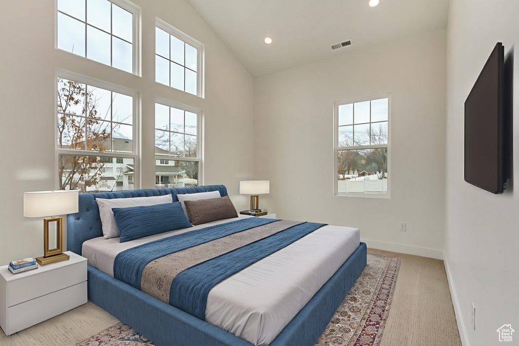 Bedroom with recessed lighting, high vaulted ceiling, and light colored carpet