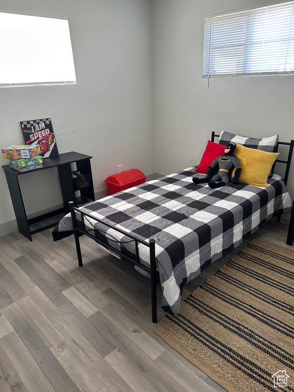 Bedroom featuring light wood-style floors and baseboards
