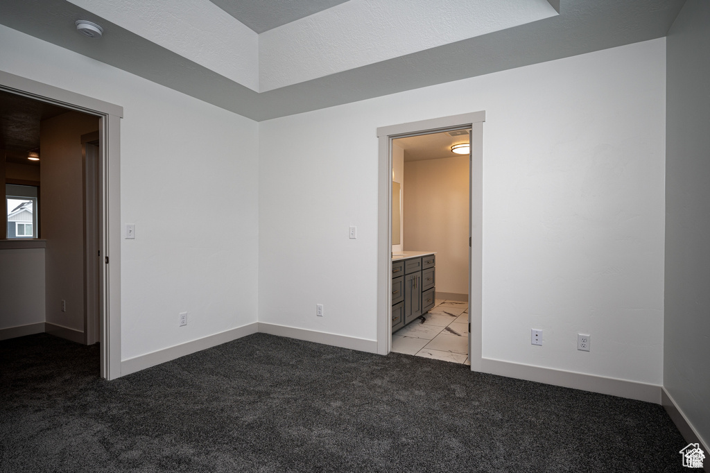 Unfurnished bedroom featuring baseboards and light carpet