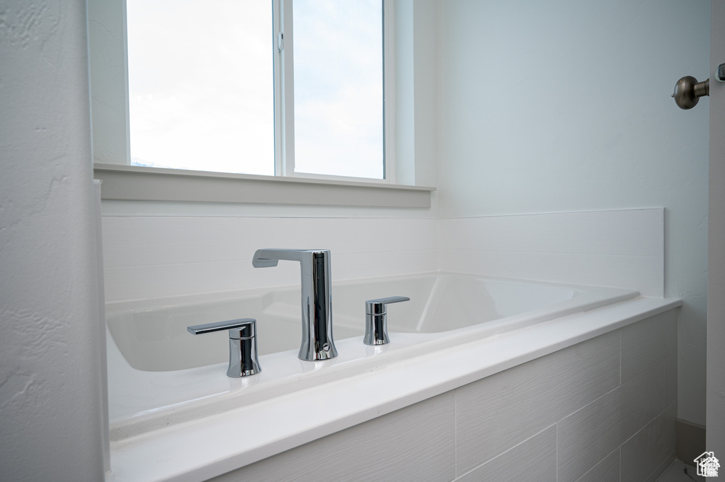 Bathroom featuring plenty of natural light and a bath
