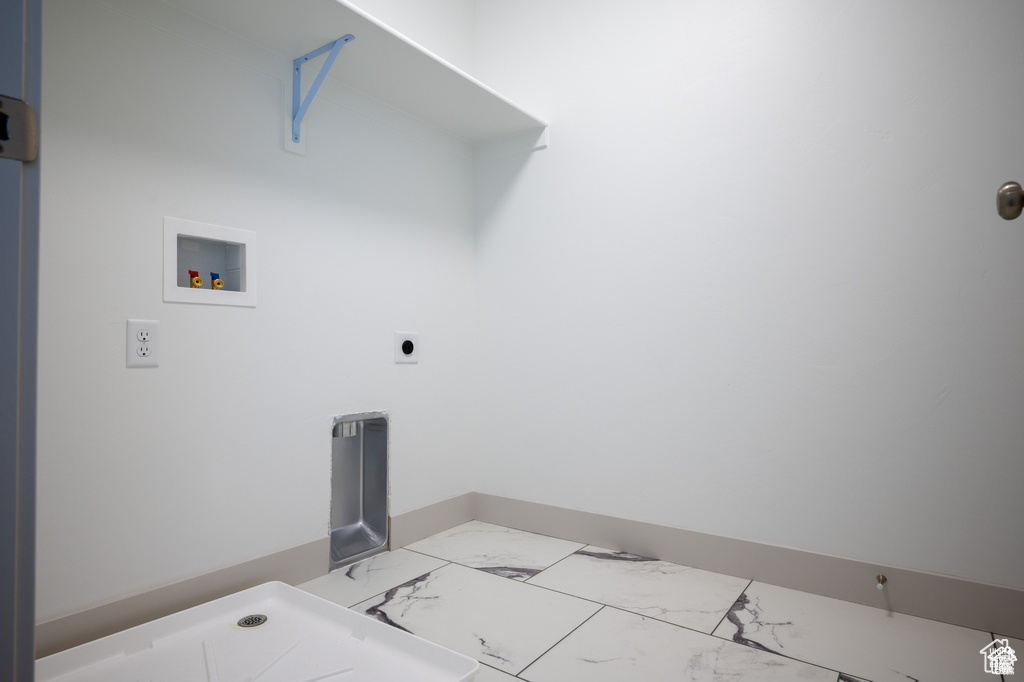 Washroom featuring washer hookup and marble look tile flooring