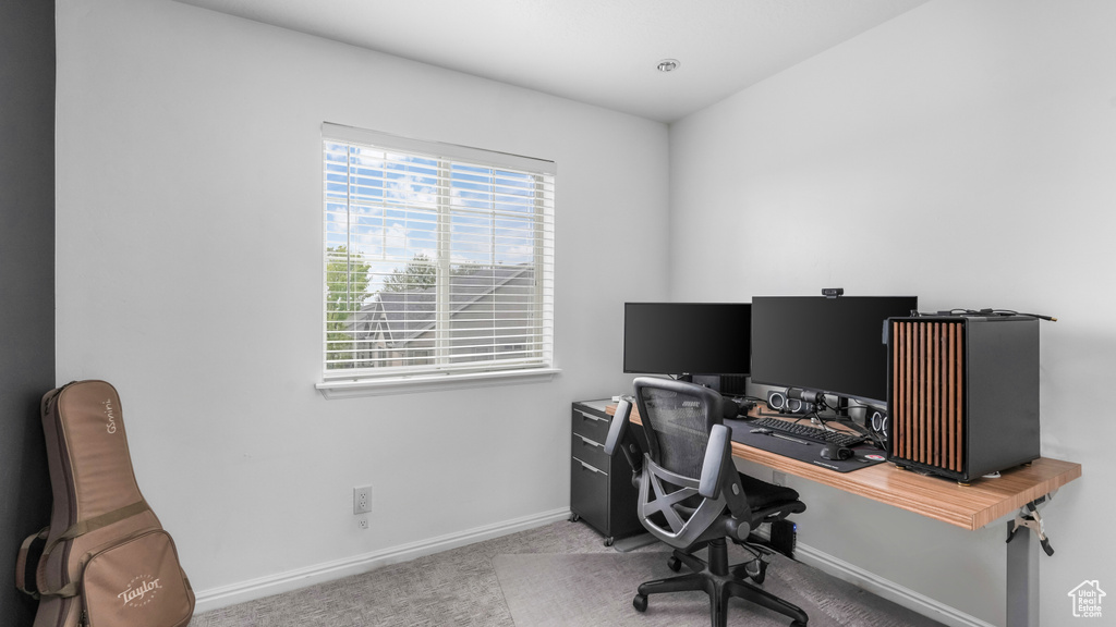 Home office featuring baseboards and carpet flooring