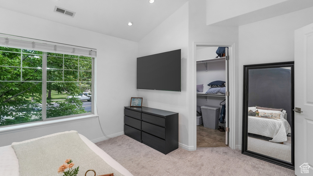 Carpeted bedroom with vaulted ceiling, baseboards, a spacious closet, and recessed lighting