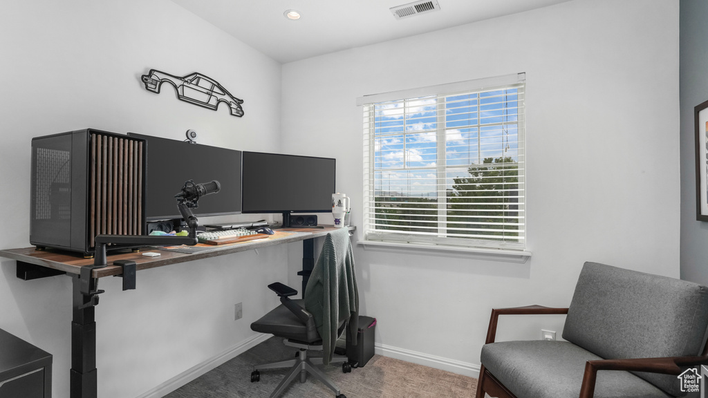 Carpeted office space featuring baseboards