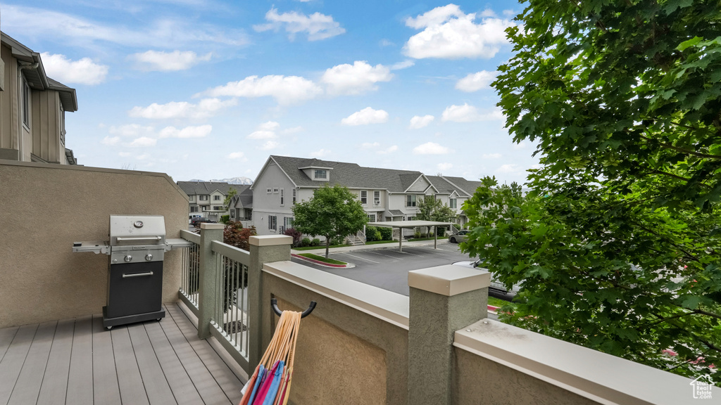 Deck with a residential view and a grill