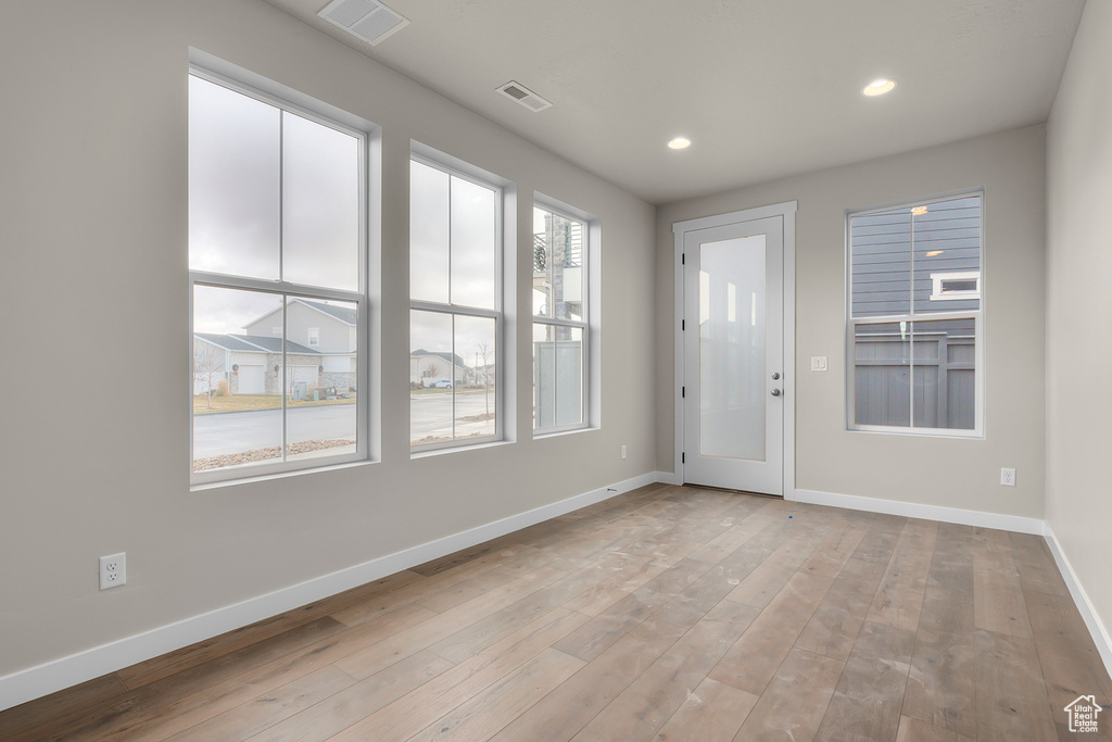 Spare room with baseboards, recessed lighting, and wood-type flooring