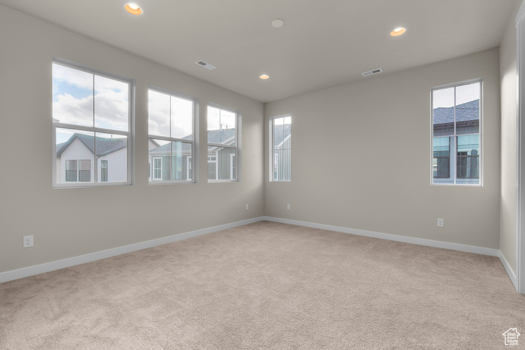Empty room with carpet flooring, baseboards, and recessed lighting