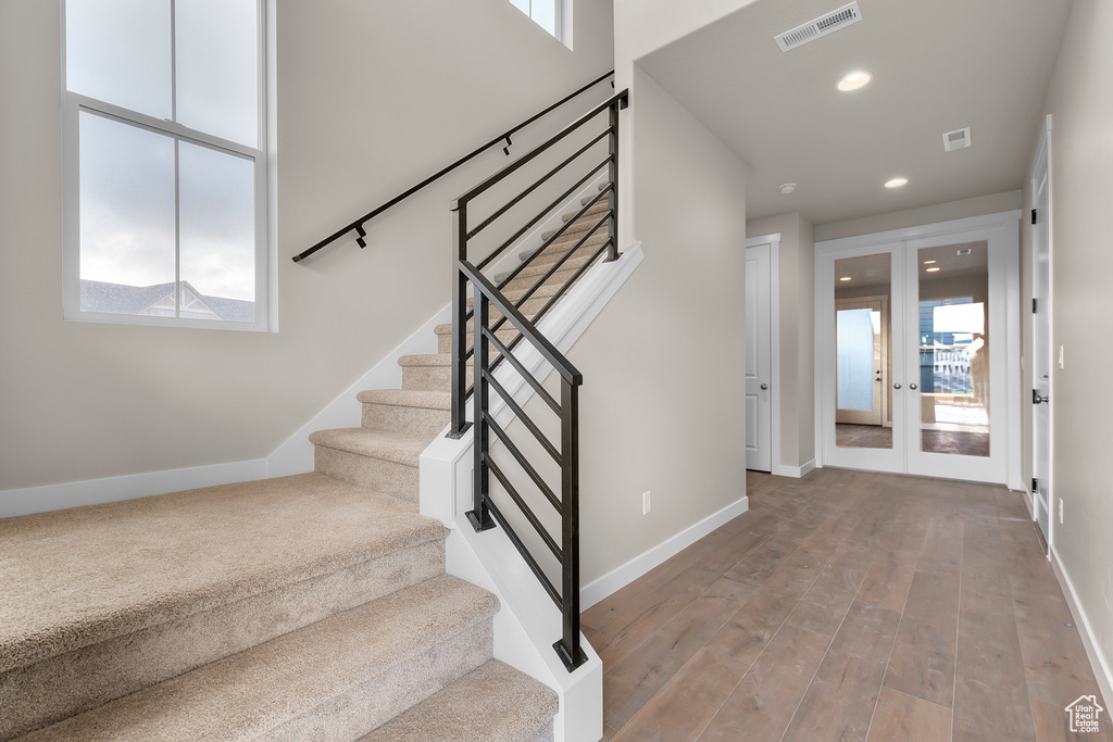 Entryway with stairway, french doors, baseboards, and recessed lighting