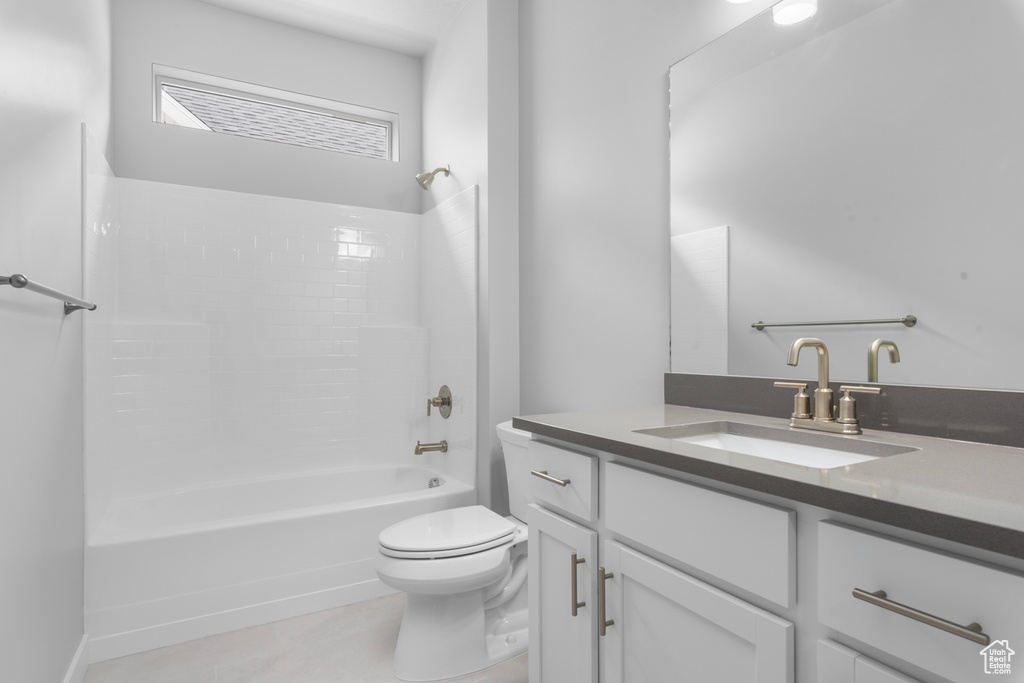 Bathroom with vanity, toilet, and  shower combination