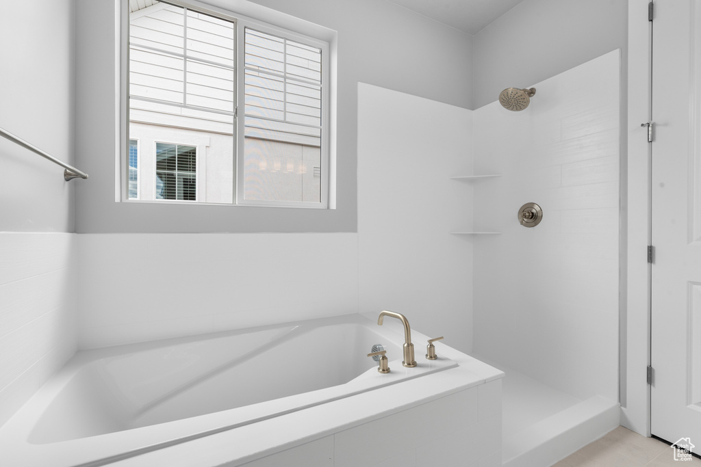 Bathroom with a garden tub and a shower