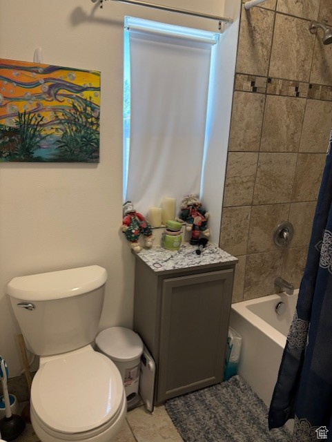 Bathroom with shower / tub combo and toilet