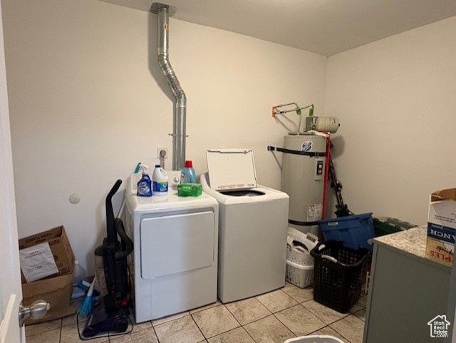 Laundry room with independent washer and dryer, secured water heater, and light tile patterned floors