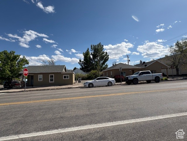View of asphalt road with traffic signs and sidewalks