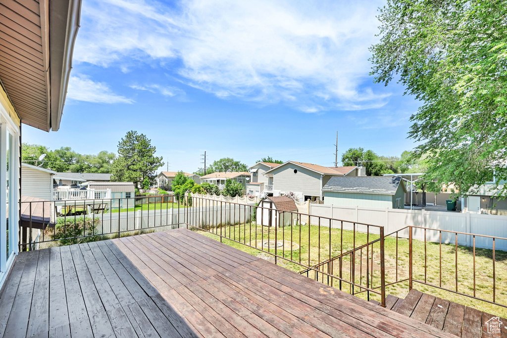 Wooden terrace featuring a residential view