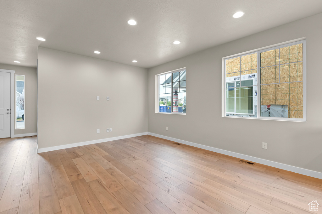 Spare room with baseboards, recessed lighting, and light wood-style flooring