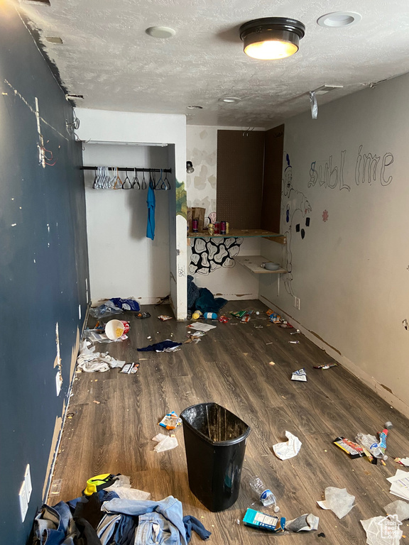 Spare room with wood finished floors and a textured ceiling