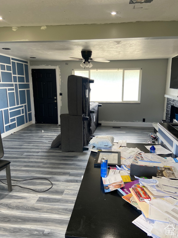 Living area featuring baseboards, ceiling fan, wood finished floors, and recessed lighting