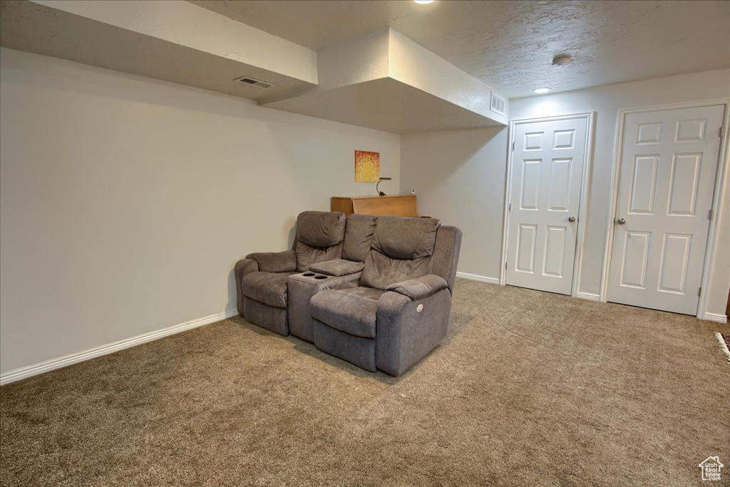 Sitting room featuring carpet and baseboards