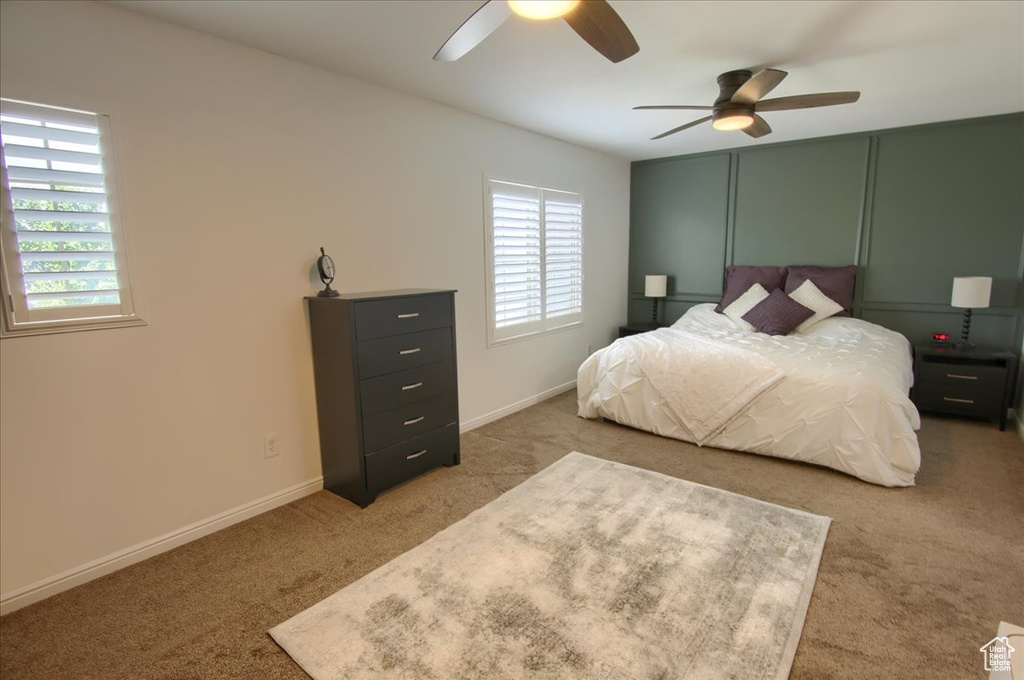 Bedroom featuring carpet, ceiling fan, and baseboards