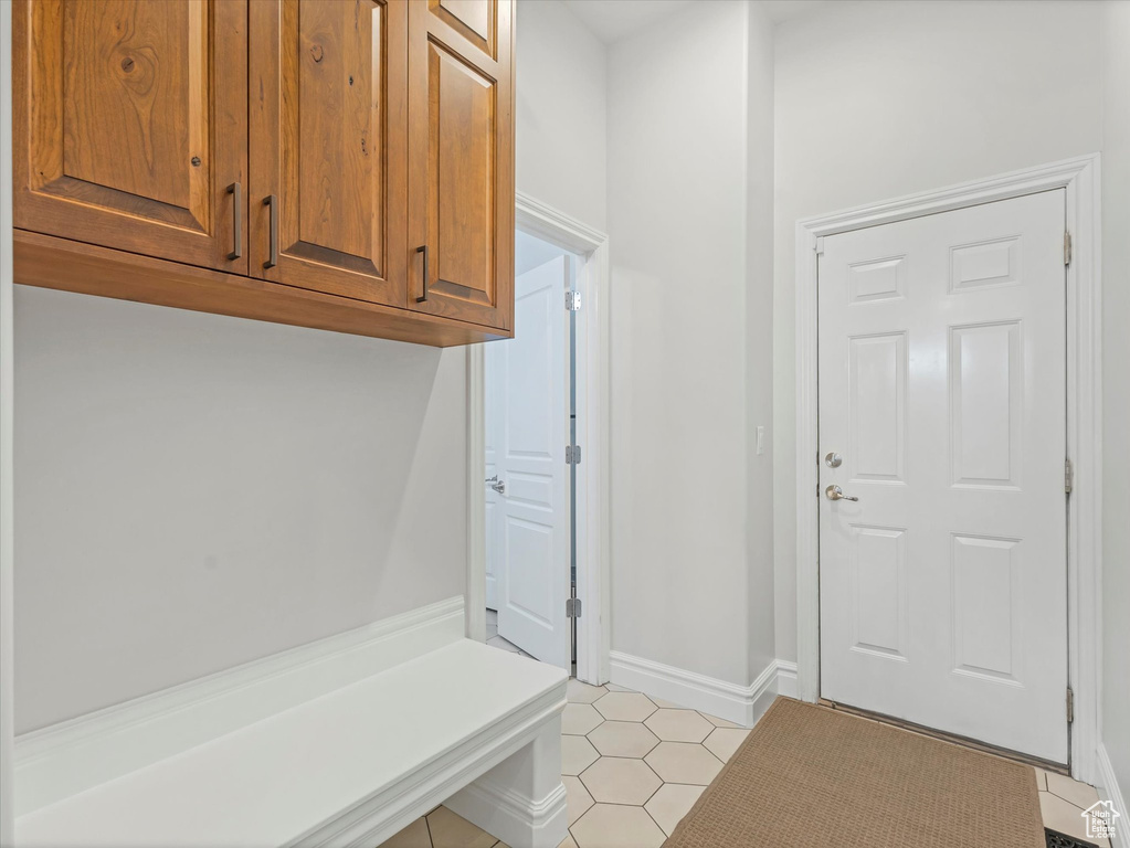 Mudroom with light tile patterned floors