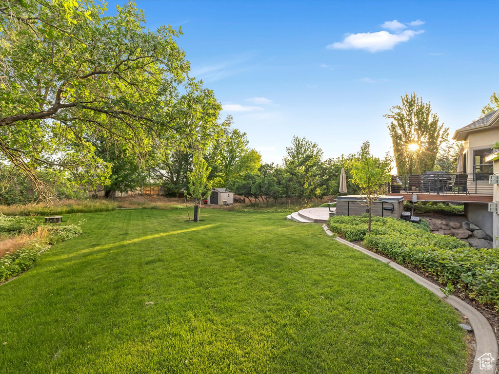 View of green lawn featuring a shed