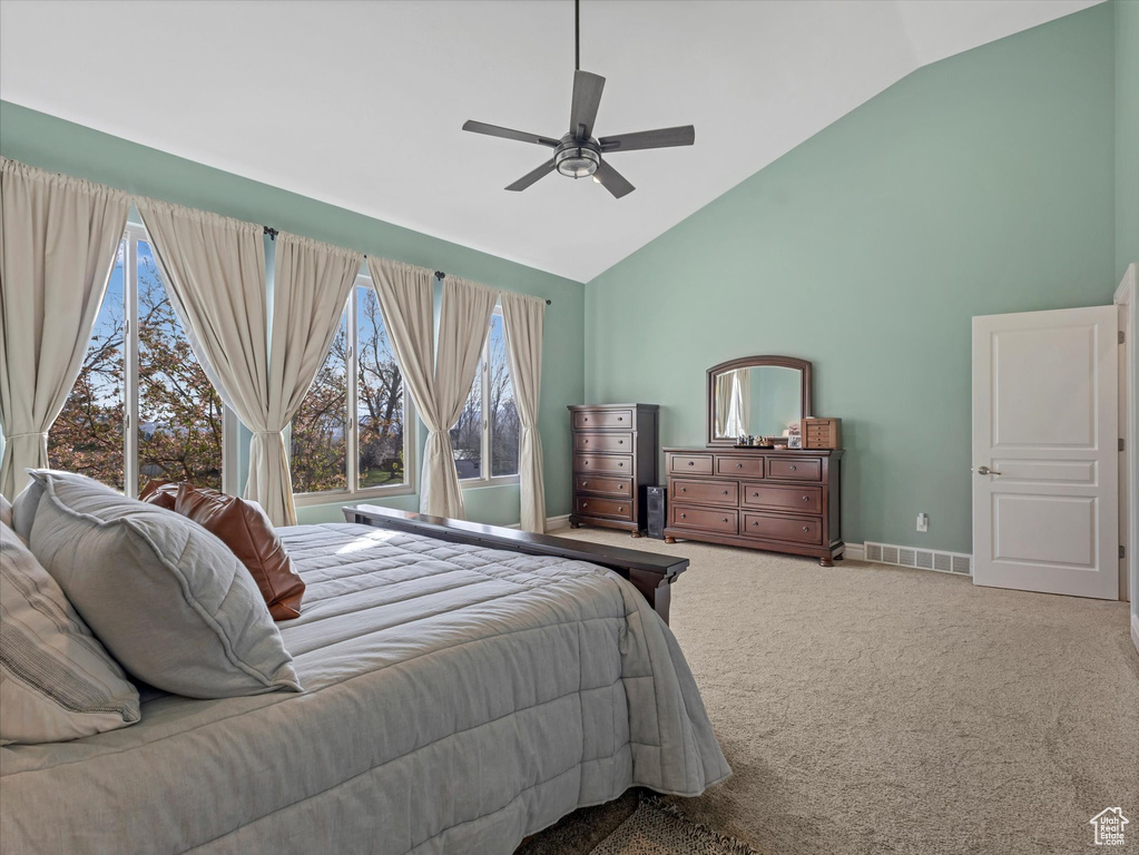Bedroom with high vaulted ceiling, carpet, baseboards, and a ceiling fan