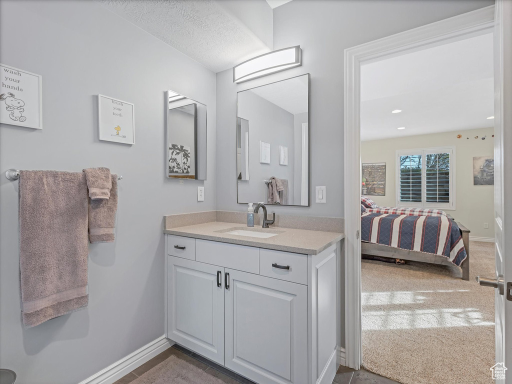 Ensuite bathroom with vanity and baseboards