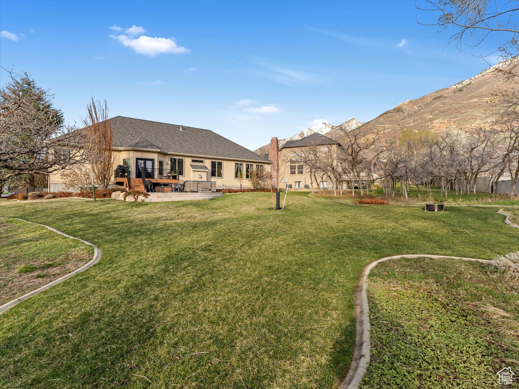 View of green lawn with a patio and french doors