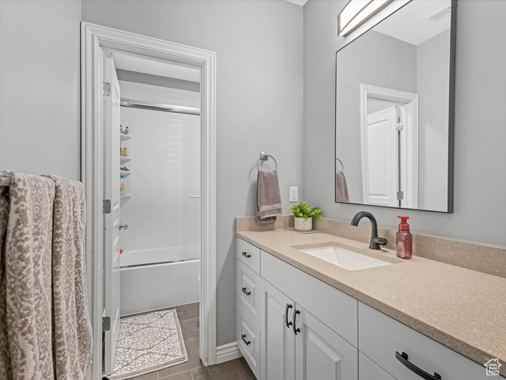 Full bath featuring vanity and shower / washtub combination