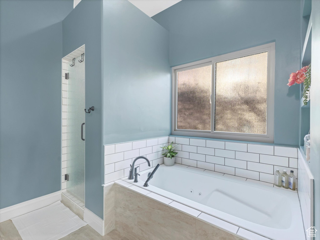 Bathroom with a shower stall, a whirlpool tub, and tile patterned floors