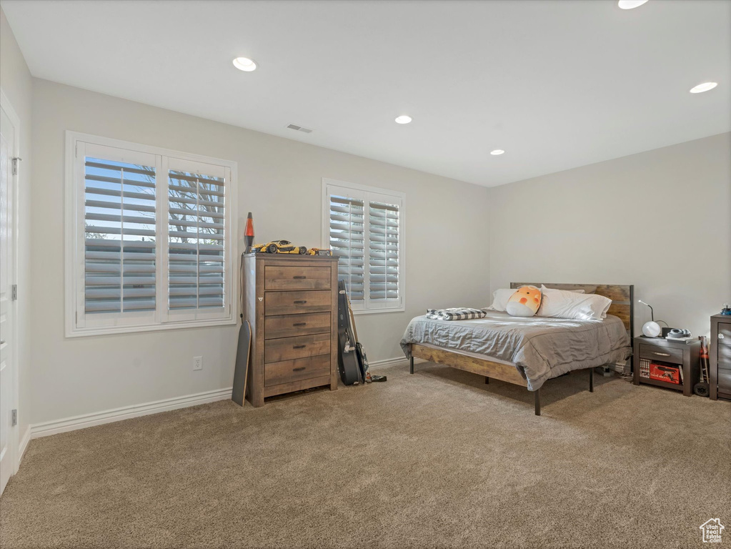 Carpeted bedroom featuring baseboards and recessed lighting