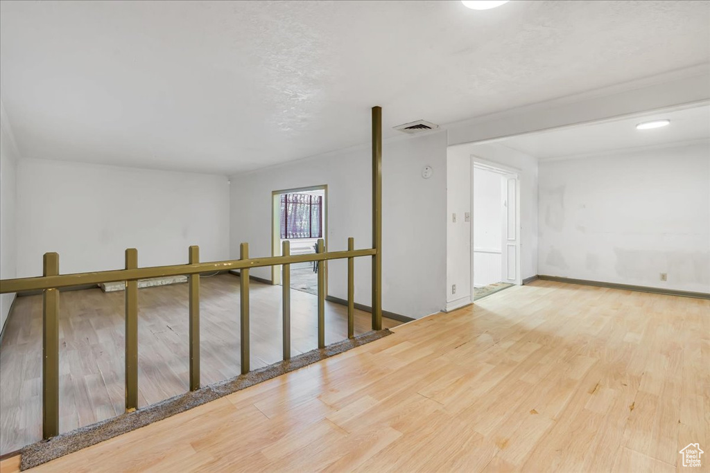 Empty room featuring wood finished floors and baseboards