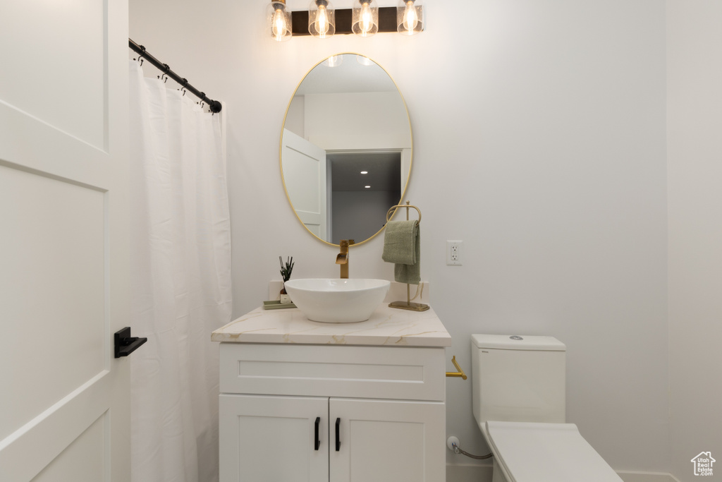 Full bathroom with toilet and vanity