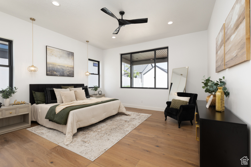 Bedroom with wood finished floors, recessed lighting, baseboards, and ceiling fan