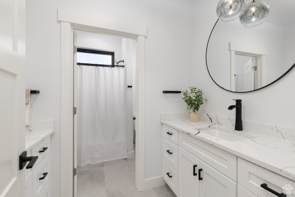 Bathroom with vanity and baseboards