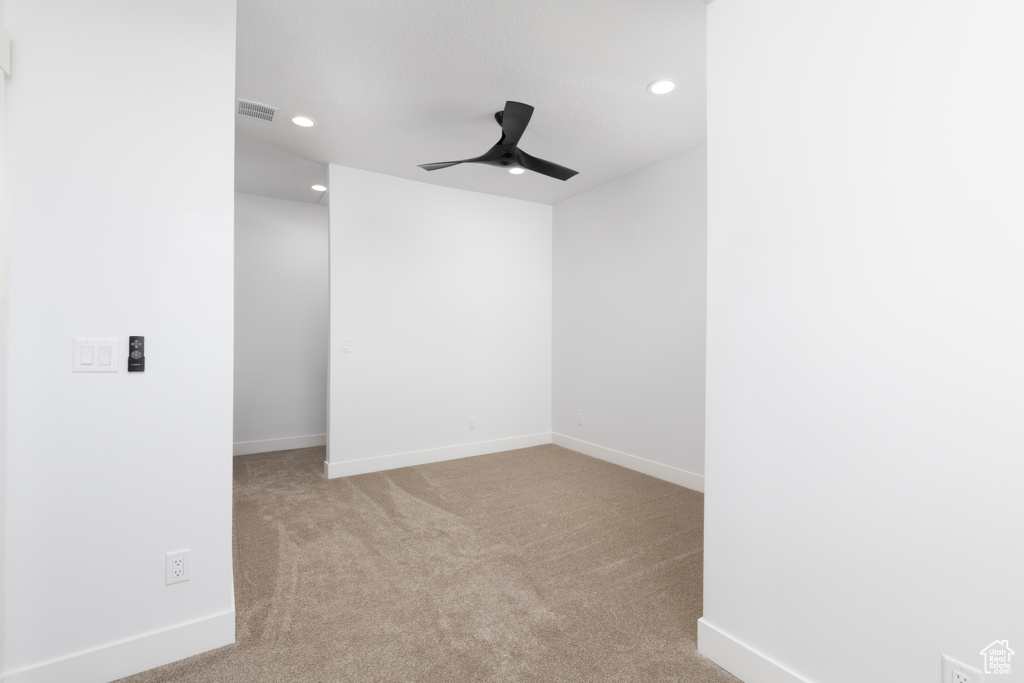 Spare room with a ceiling fan, recessed lighting, carpet flooring, and baseboards