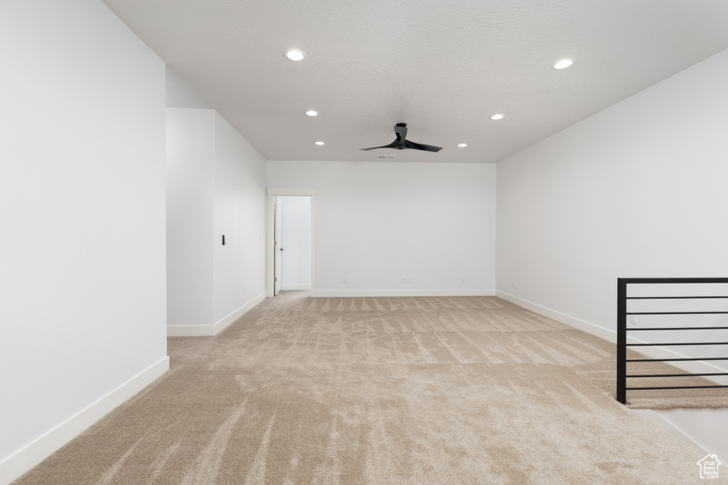 Spare room with light colored carpet, recessed lighting, baseboards, and a ceiling fan