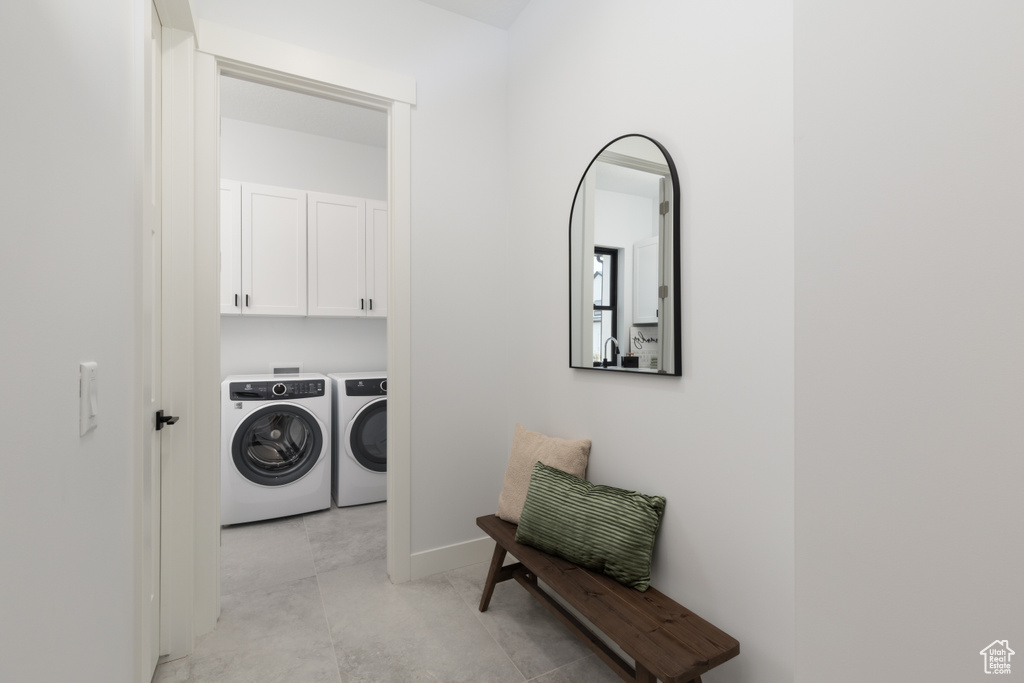 Washroom with washing machine and clothes dryer and cabinet space