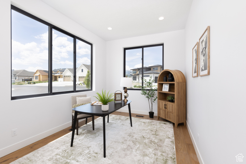 Home office with wood finished floors, baseboards, and recessed lighting