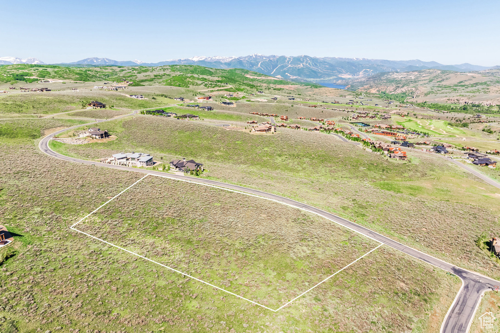 Overview of rural landscape featuring a mountain backdrop and property boundaries highlighted