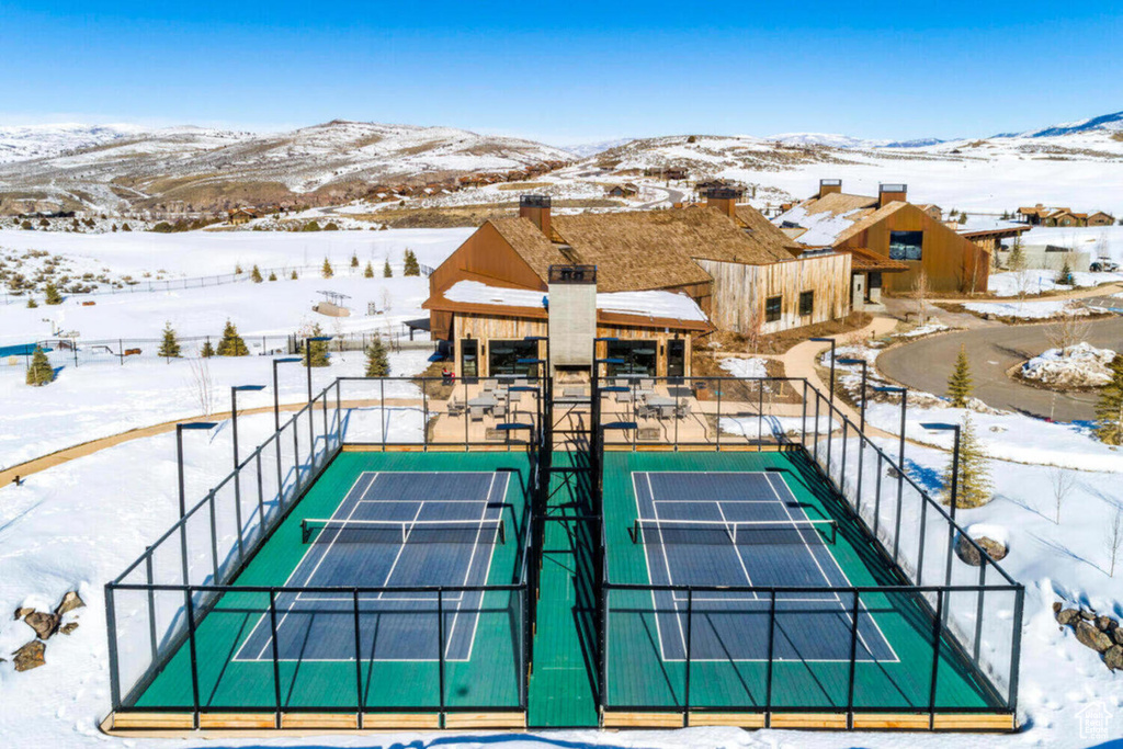 View of tennis court with a mountain view