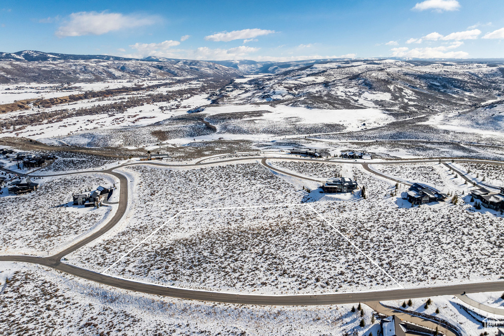 Snowy aerial view featuring a mountain view