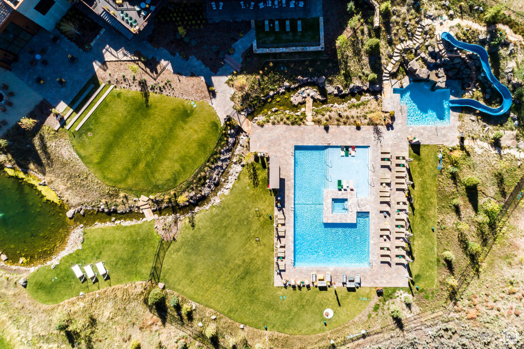 Aerial view of property and surrounding area featuring a pool area