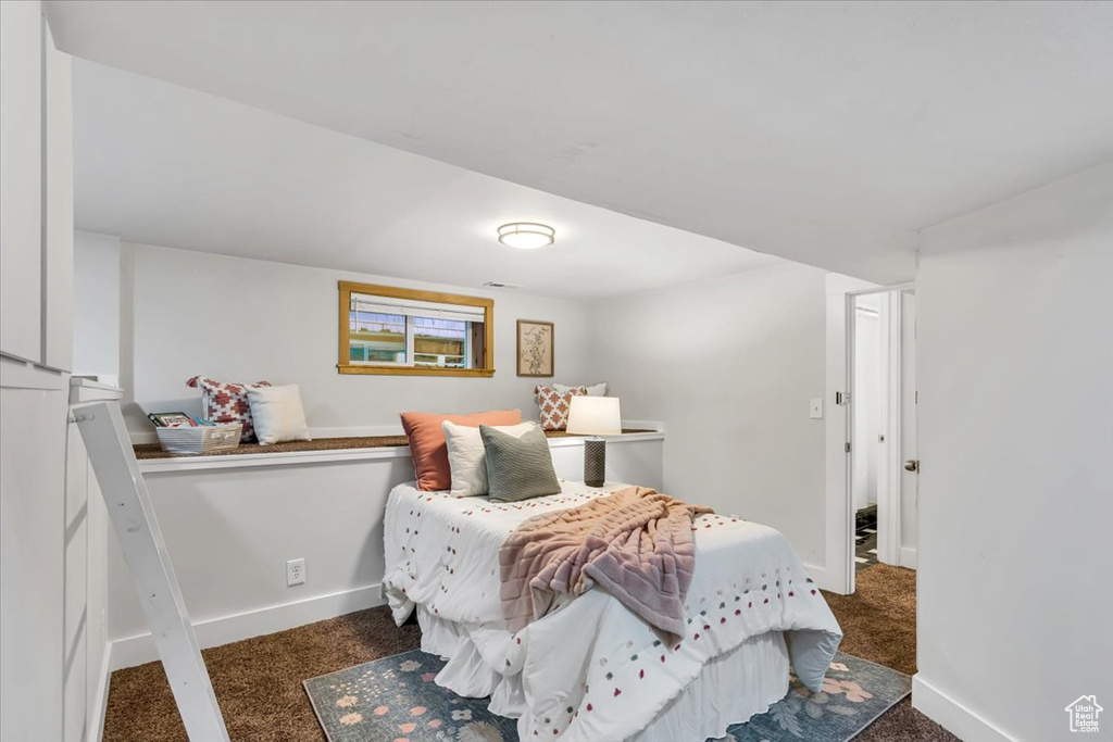Bedroom featuring carpet floors and baseboards