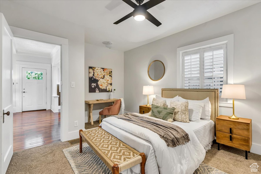 Bedroom featuring carpet flooring, baseboards, and a ceiling fan